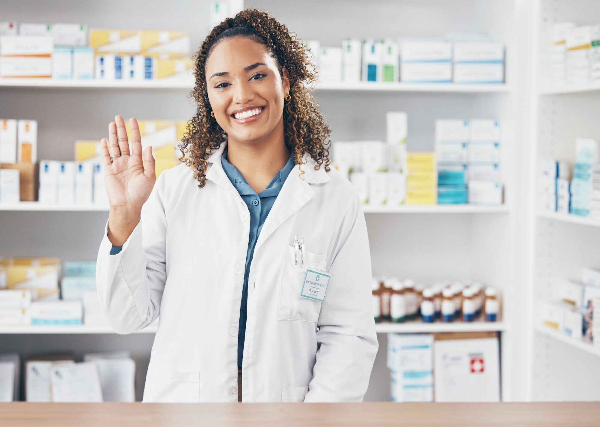 Hello, pharmacist or portrait of woman in pharmacy with smile in customer services or wellness clin